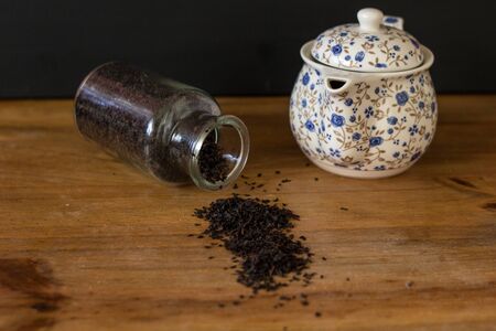 black tea in a bottle and a teapot of flowersの写真素材