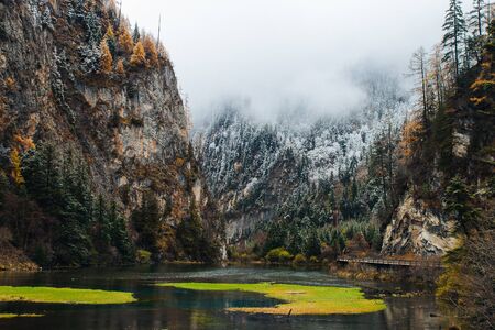 snow mountain in Winter season full with fogの写真素材
