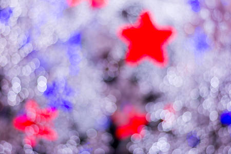 Defocused abstract white and red stars christmas backgroundの写真素材