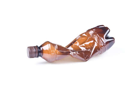 Crumpled Brown Plastic Bottle Isolated Over Whiteの写真素材