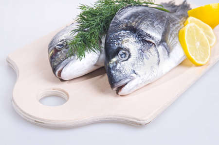Photo Of Two Gilthead Fishes On a Cutting Board