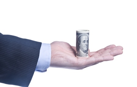 Man's Hand With a Roll Of Dollars Isolated Over Whiteの写真素材