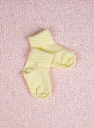Pair of baby socks on a terry towelの写真素材