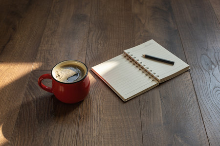 Coffee in a cup on a wooden surfaceの写真素材