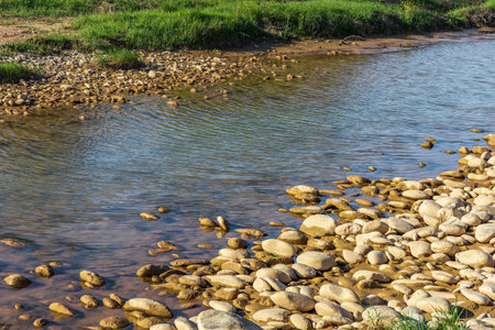 Background with river and stone shoreの写真素材