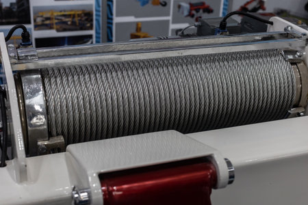 Electric winch with metal cable for heavy objects