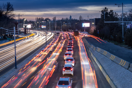 Tashkent, Uzbekistan - March 6, 2023: Road traffic of cars with blurred auto headlightsのeditorial素材