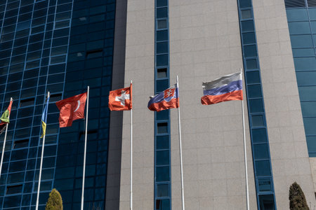 Tashkent, Uzbekistan - March 11, 2023: Flags on flagpoles for news topicsのeditorial素材