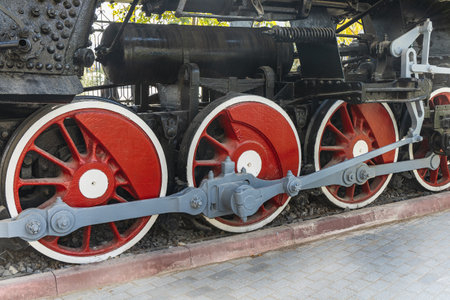 Mechanical wheels of a transport steam locomotive on rails.