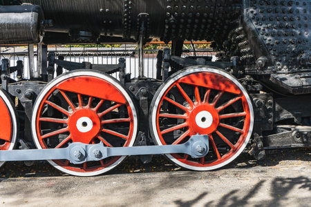 Mechanical wheels of a transport steam locomotive on rails.の写真素材