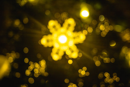 Abstract background with Christmas or New Year festive sparkling light in the form of defocused bokeh.の写真素材