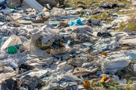 Dirty ecology environment with scattered garbage and waste of human activity.
