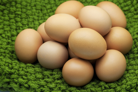 Fresh organic chicken Eggs on green yarns selective focusの写真素材