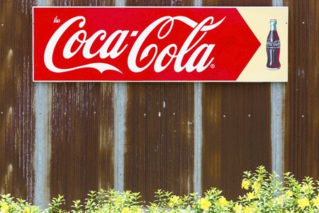 Bangkok, Thailand - May 26,2018 : An advertising sign of Coca-Cola,Coke on the rusty old zinc wall in Thailandのeditorial素材
