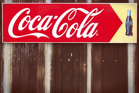 Bangkok, Thailand - May 26,2018 : An advertising sign of Coca-Cola,Coke on the rusty old zinc wall in Thailandのeditorial素材
