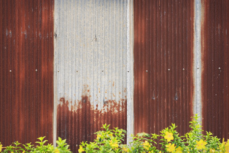 The old rusty zinc fence with screw for texture or backgroundの写真素材