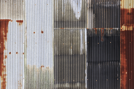 The old rusty zinc fence with screw for texture or backgroundの写真素材