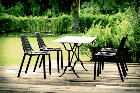 Modern designed outdoor furniture set relax corner table and chairs on wooden floor in the gardenの写真素材