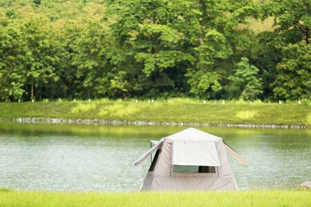 The tent of tourists at the edge of the lake in the morningの写真素材