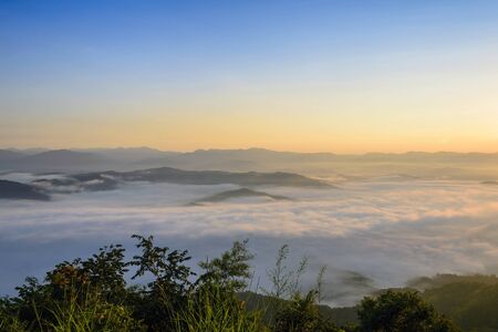 sunrise with the fog from the top of the mountain sceneの写真素材