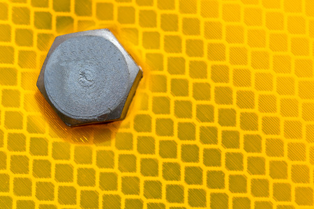 close-up of the bolt head on the yellow reflection surface traffic signの写真素材