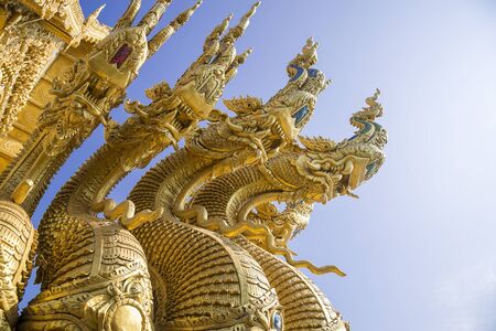 the naga head sculpture,naga statue in the Buddhist temple with the blue sky