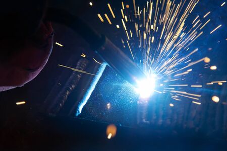 the welding spark light in close-up scene,the torch of welging machine with the spark light in blue
