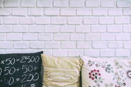 the white brick wall with the pillows,white brick wall in leaving room and the pillows