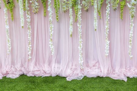 Flower backdrop,the backdrop in the wedding ceremony with the grass and flower.The beautiful flower backdrop for ceremony of wedding.の写真素材