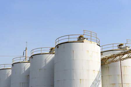 The old  big industrial container tank for keep the chemical liquid  with the blue sky