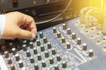 The hand adjust mixer table or fader board for music production process