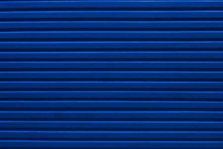 The sheet metal wall texture of factory building in the dark sceneの写真素材