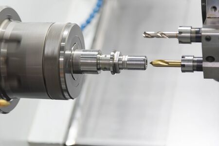 The CNC lathe machine or Turning machine  drilling the metal rod with the drill tool and center drill tool .The hi-technology machining concept.の写真素材