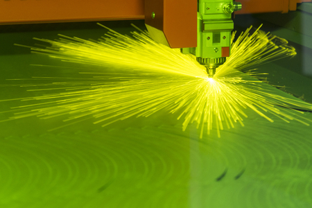 The fiber laser cutting machine  cutting the sheet metal with the sparking light.の写真素材
