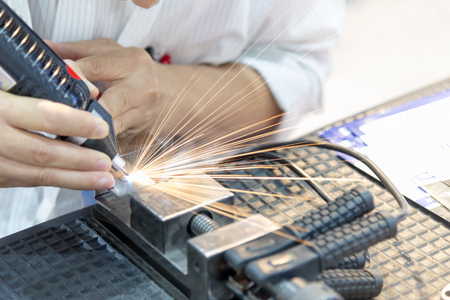 The welding sparking light and the welding torch.の写真素材