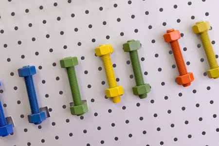 The multi-color of  screw bolt and nut  attach at the board.the industrial toolの写真素材