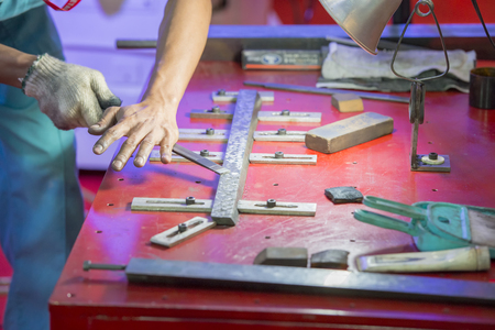 The hand of workers scraping the slide way of CNC machine.The flatness process for CNC machine partの写真素材