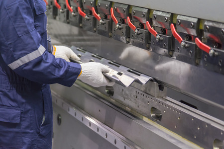 The technician operator use hydraulic bending machine. Metal working conceptの写真素材