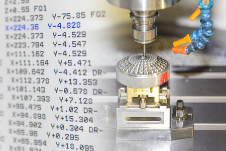 The abstract scene of CNC milling machine cutting precision mold part and G-code data.の写真素材