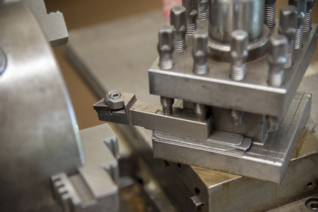 The  lathe machine with cutting tool.The manual lathe machine.