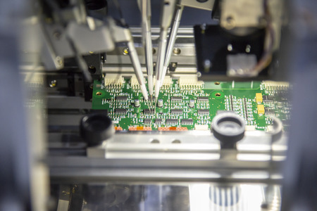 The production line of electronic board with microchip in the light blue scene.The electronics board...