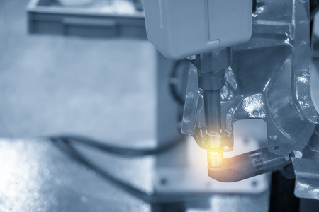 The welding robot machine for spot welding automotive part in the light blue scene.Industrial 4.0 concept for modern manufacturing process.の写真素材