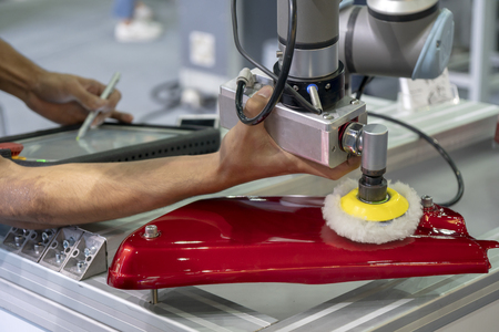 The engineer setup the robot arm in polishing automotive part process.Hi-technology manufacturing in industry.の写真素材