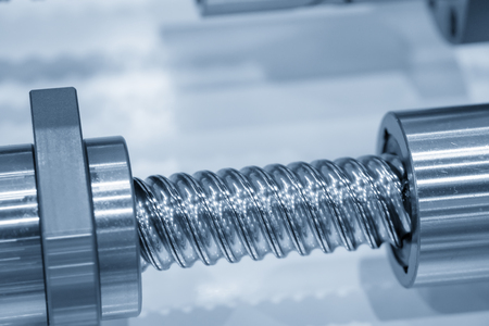 The lead screw shaft spare part of CNC machine in the light blue scene.The hi-precision CNC spare partの写真素材