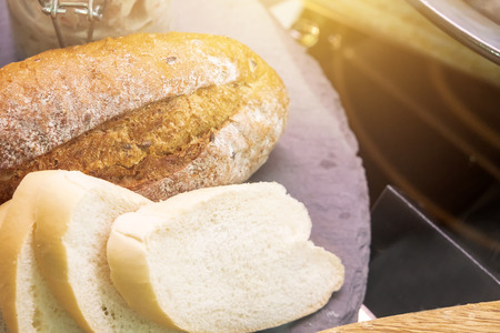 The roast bread and slice bread on the disk with morning light.の写真素材