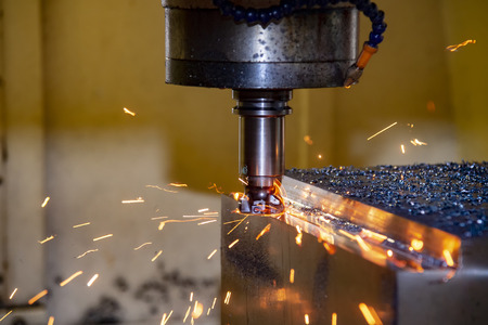 The CNC milling machine cutting the mold part in roughing  process with the burning  ship.Tool wear between cutting .の写真素材