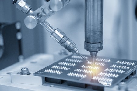 The soldering robot operation with electronic board. Electronics circuit board manufacturing process.