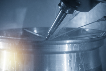 The  5-axis CNC machining center  cutting the automotive part with solid ball end mill. The hi technology manufacturing process of automotive parts.の写真素材