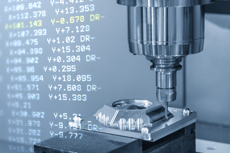 The CNC machining centre with the G-code data background. The CNC milling machine cutting the mould parts.の写真素材