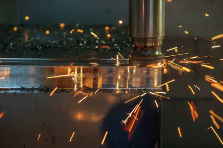 The burning  chip from the rough cutting process on CNC milling machine. The rough cutting in mould parts with indexable radius tools.の写真素材